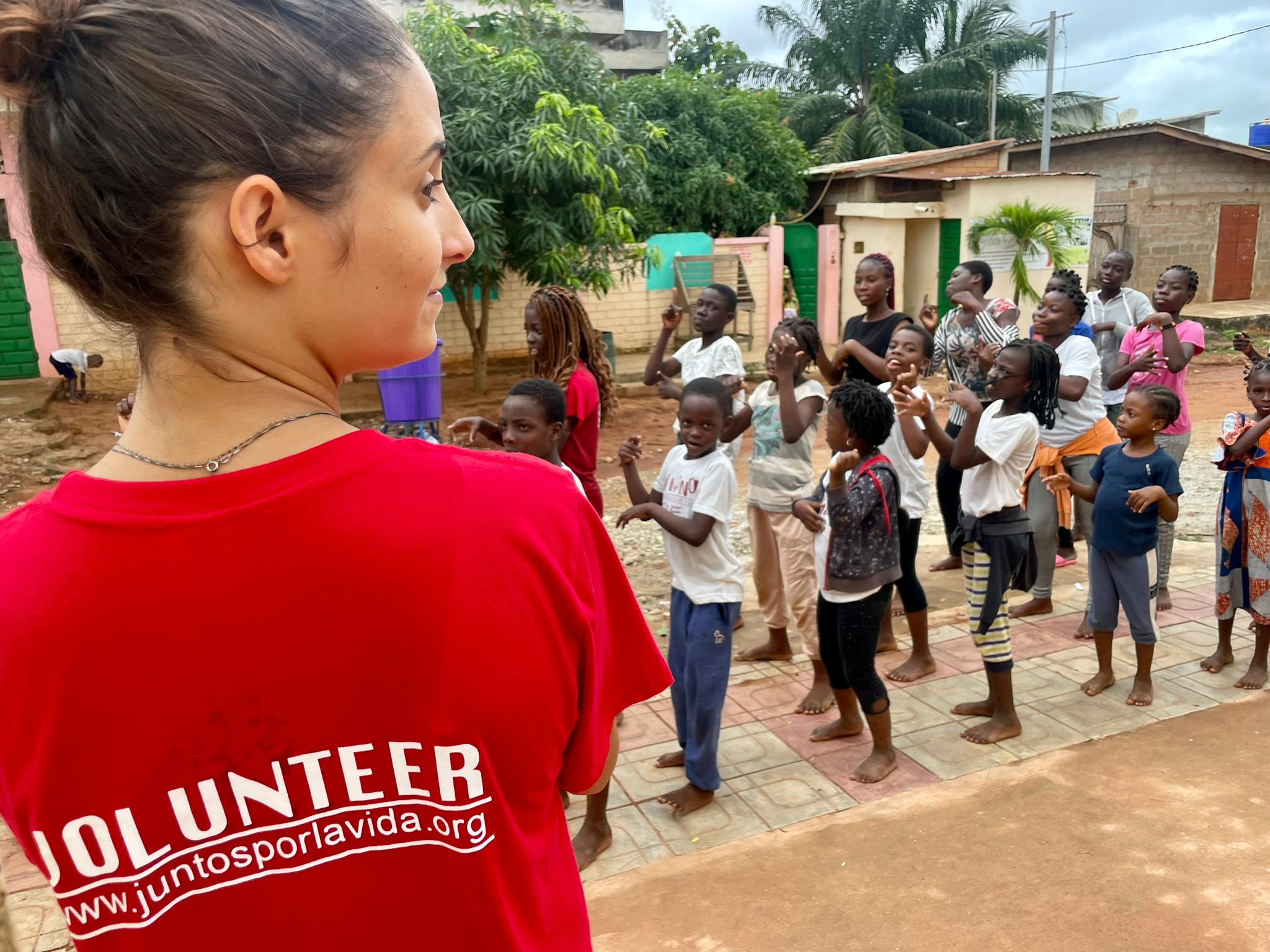 Voluntaria con niños y niñas en la escuela